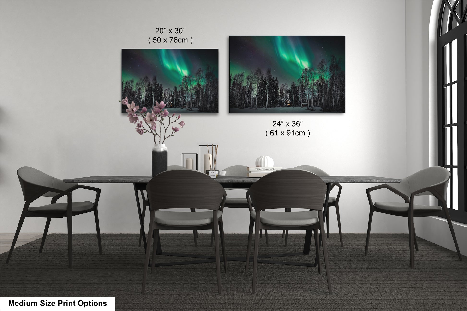 a dining table with four chairs and a vase with flowers
