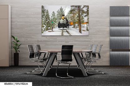 a dining room table with chairs and a painting of a man on a train
