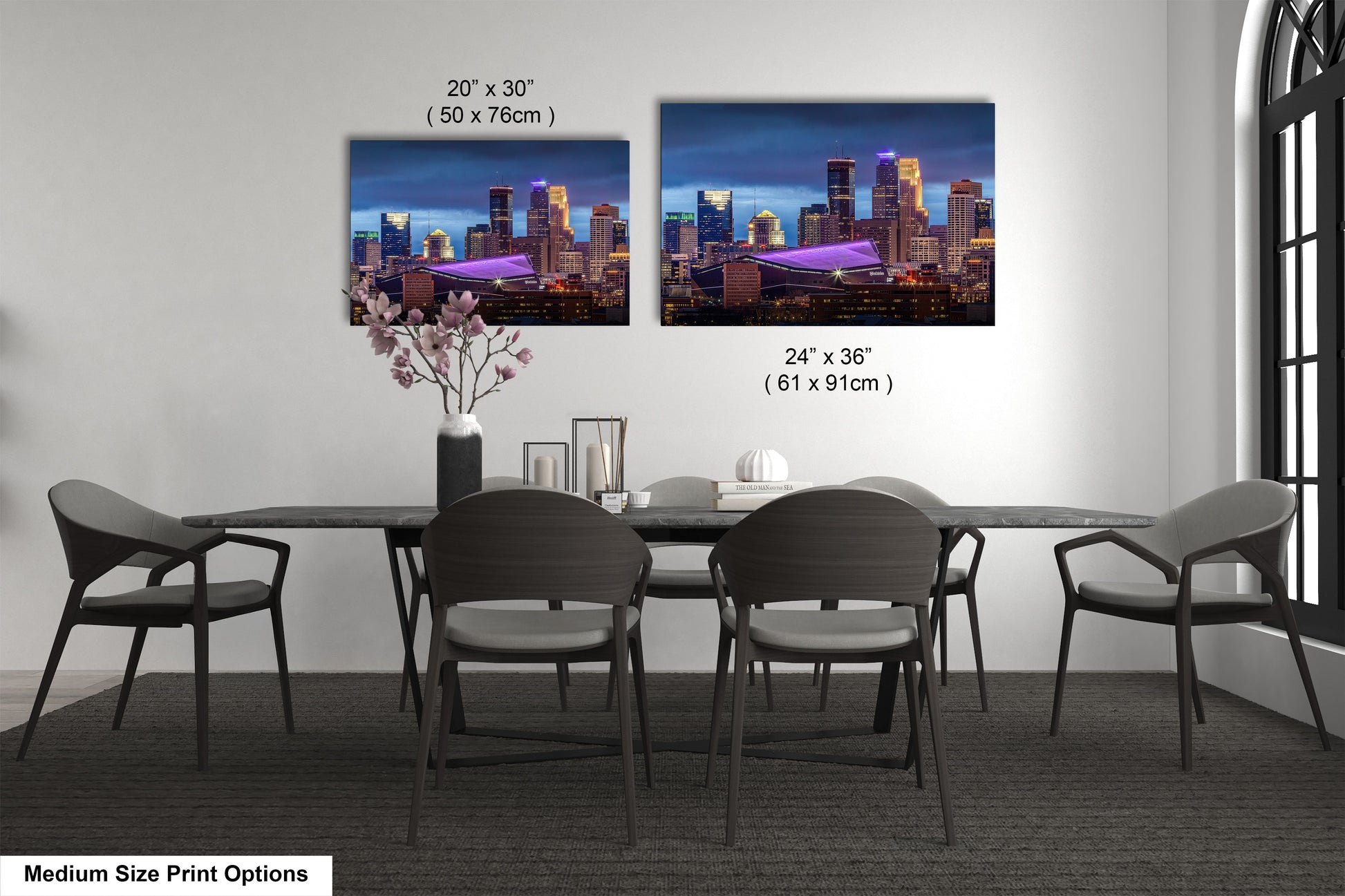 a dining room table with four chairs and a vase with flowers