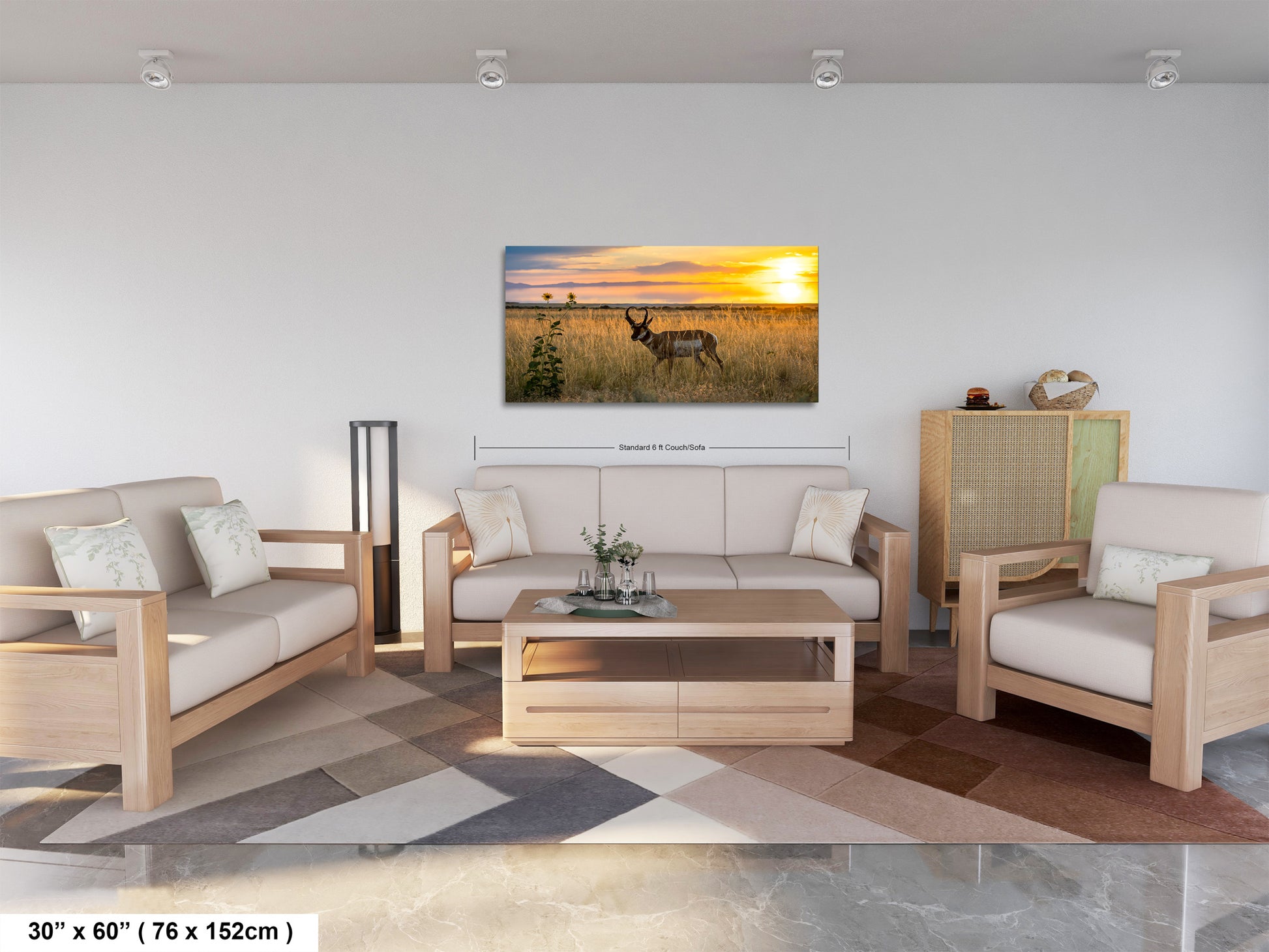 a living room with a large, framed picture of a deer in a field at sunset hanging on the wall.