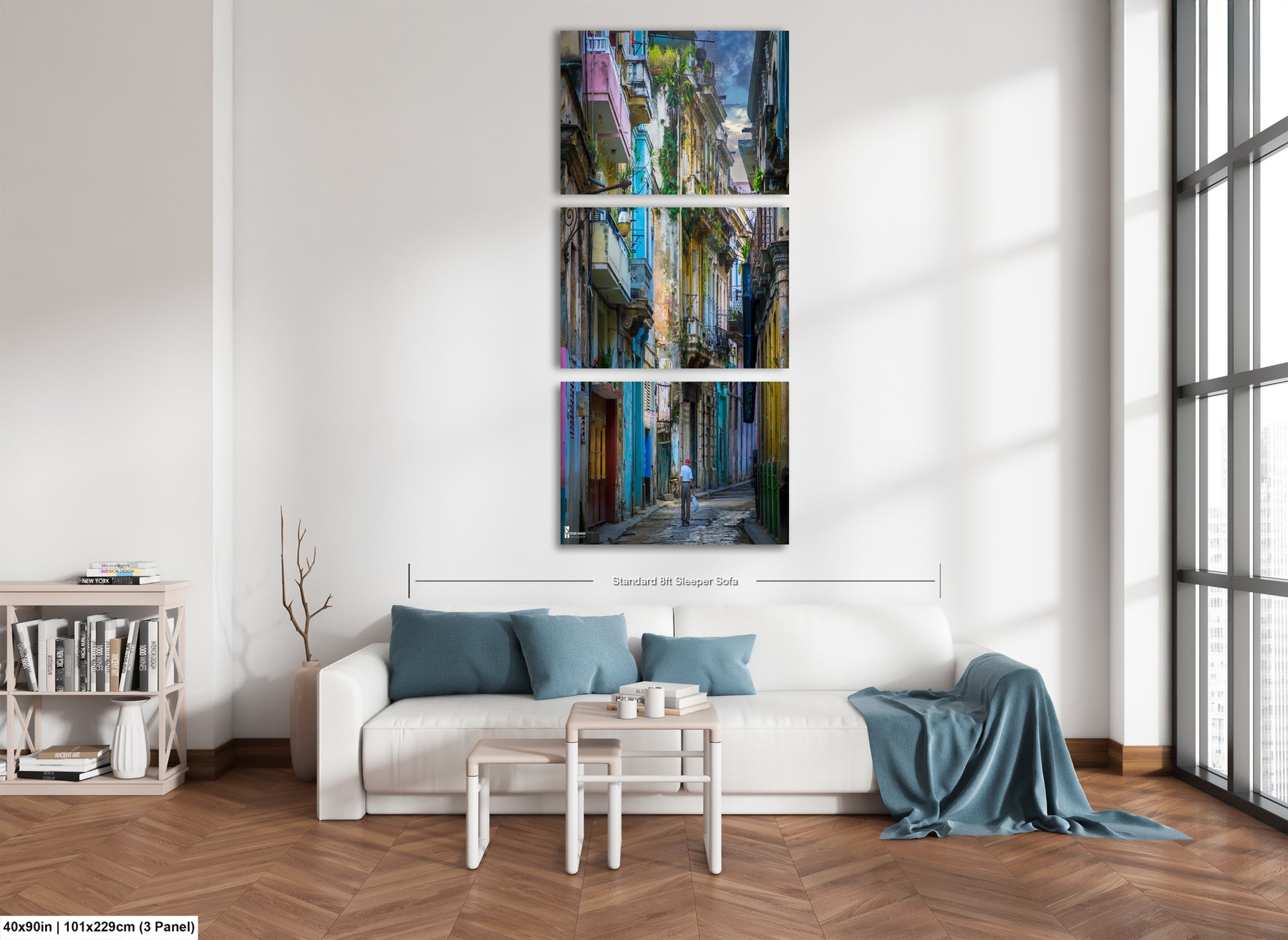 a living room with a white couch and paintings on the wall