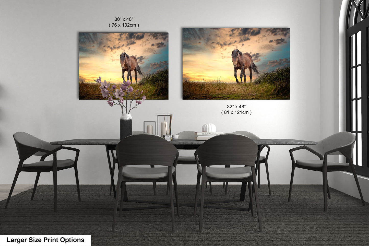 a dining room table with four chairs and two pictures on the wall