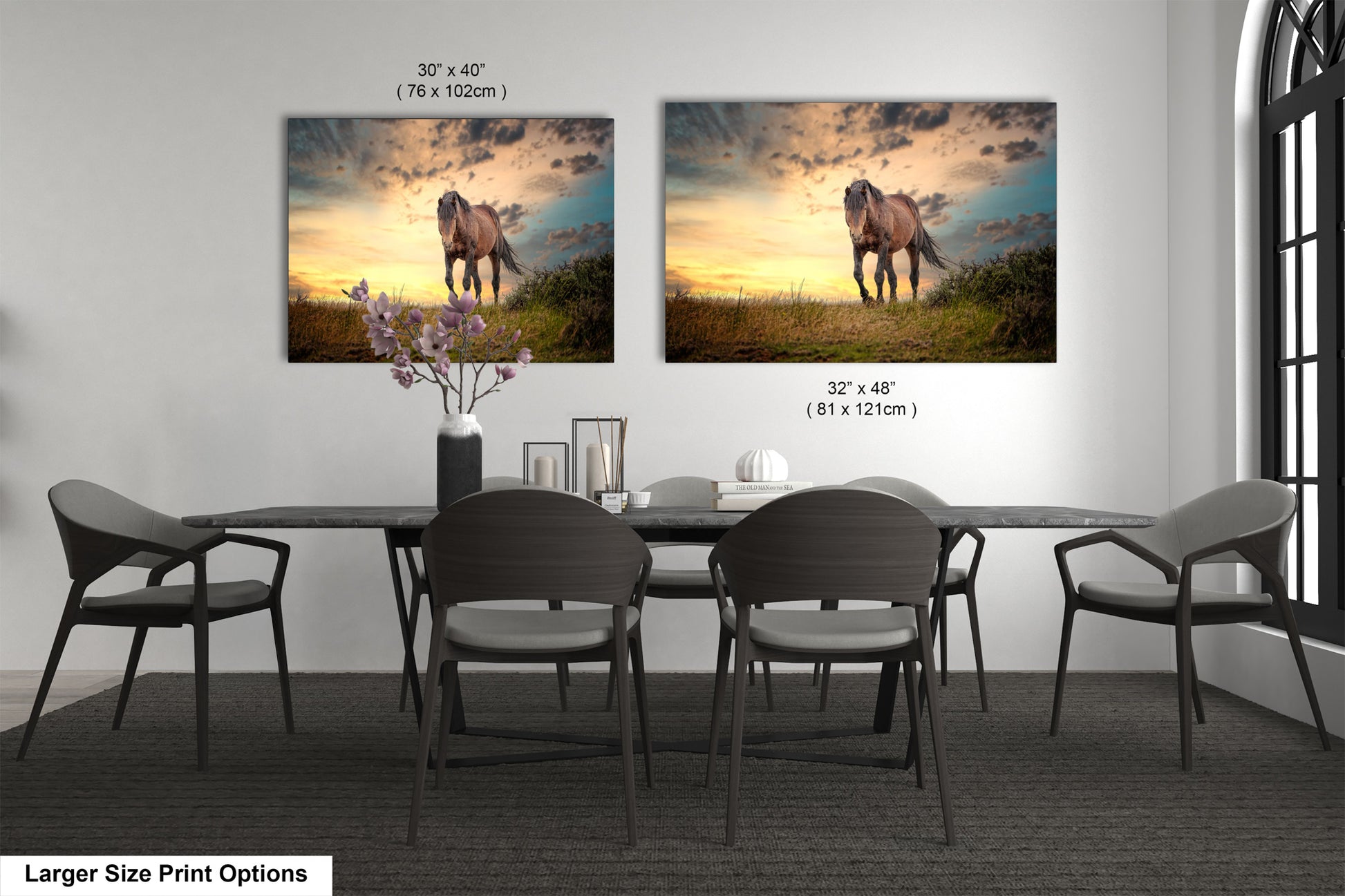 a dining room table with four chairs and two pictures on the wall