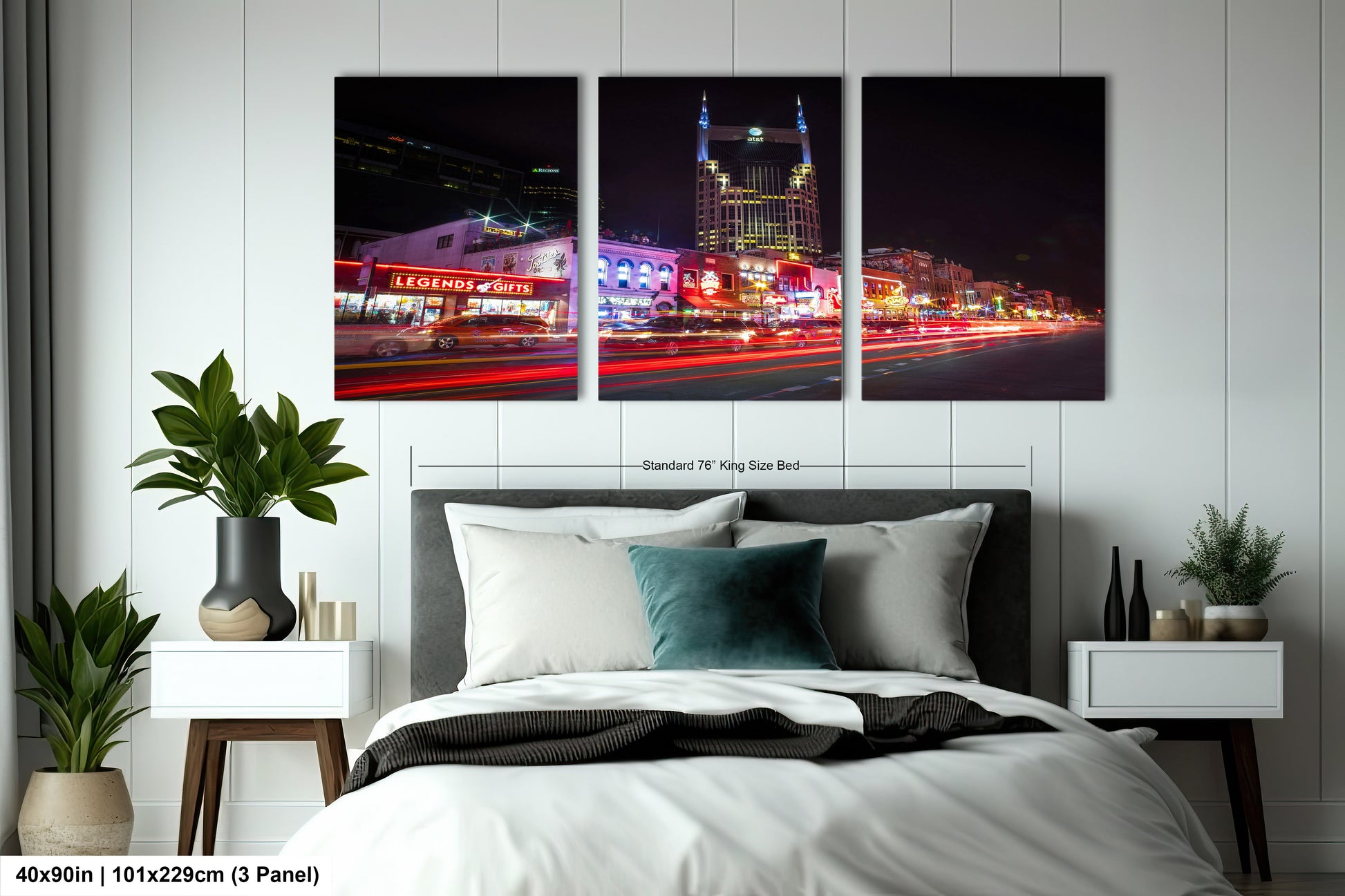 a bed with a white comforter and two pictures on the wall