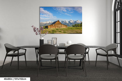 a room with a table and chairs and a painting on the wall