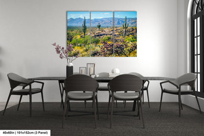 a desert landscape with mountains in the background, featuring cacti and other desert vegetation.