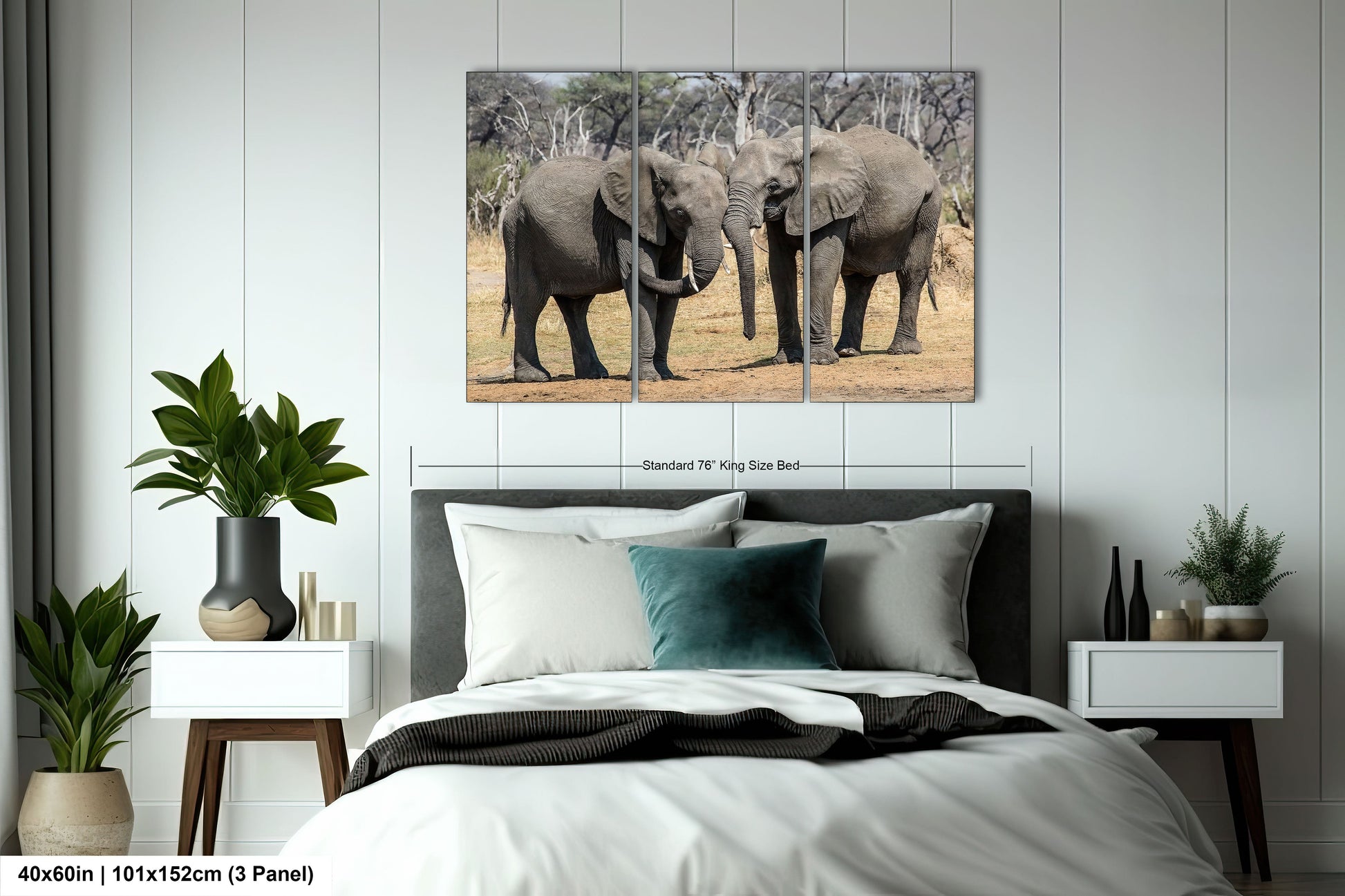 a couple of elephants standing next to each other on a bed