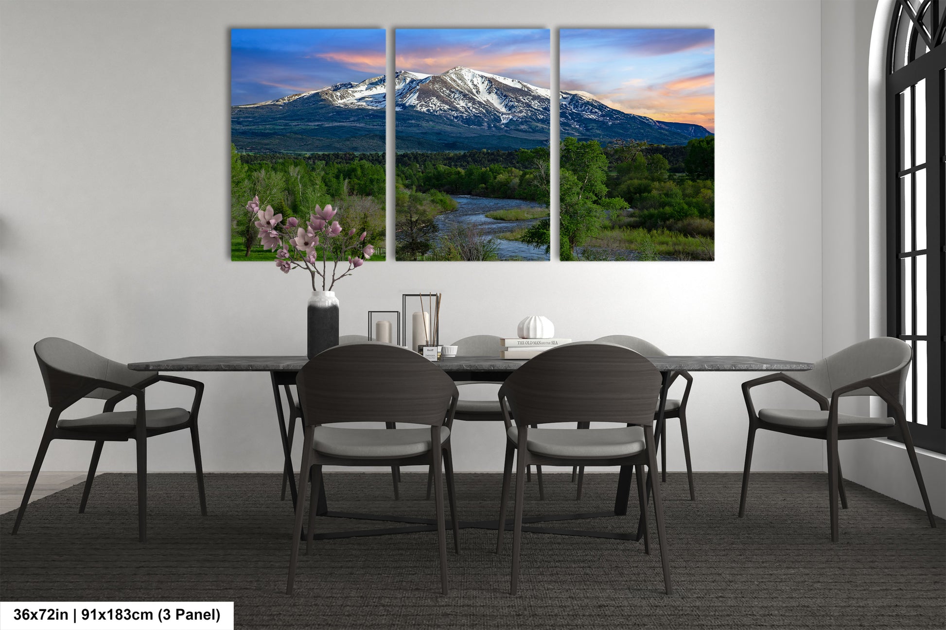a dining room table with four chairs and a mountain in the background