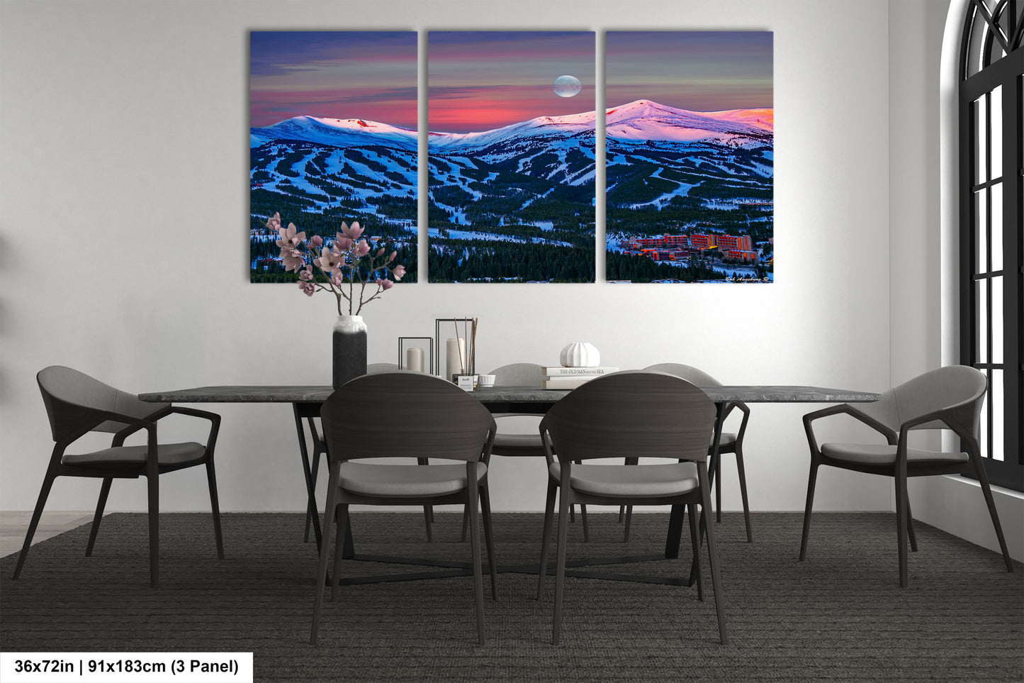 a dining room table with four chairs and a painting on the wall