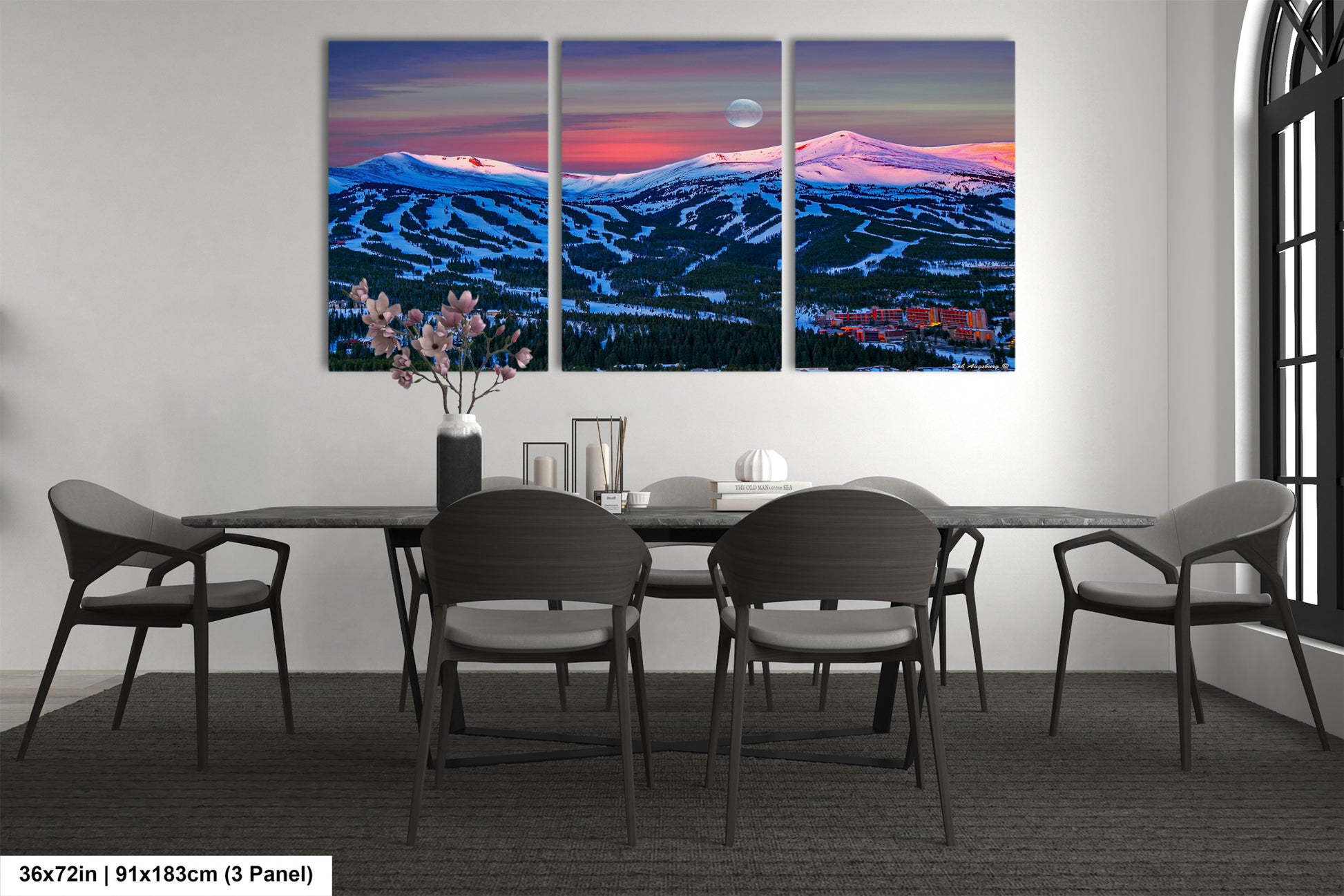 a dining room table with four chairs and a painting on the wall