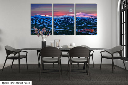a dining room table with four chairs and a painting on the wall
