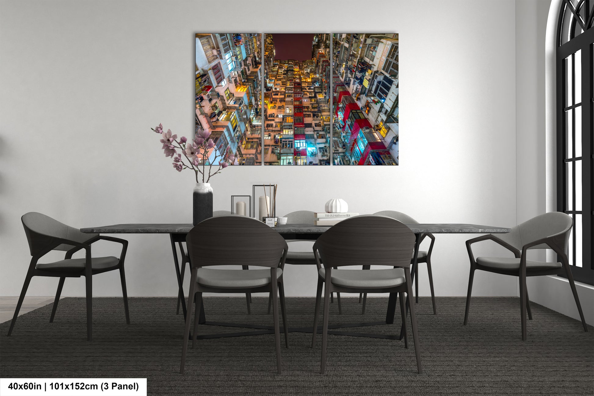 a dining room table with chairs and a painting on the wall