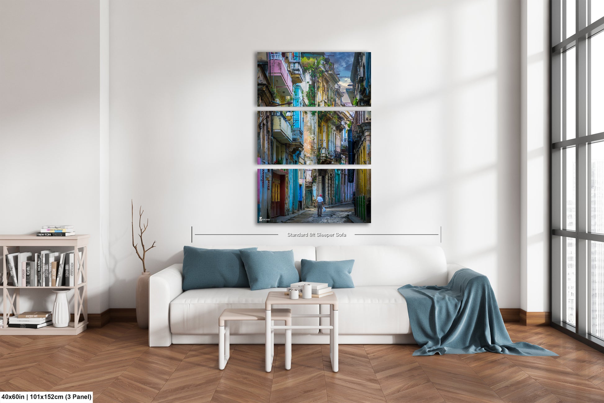 a living room with a white couch and paintings on the wall