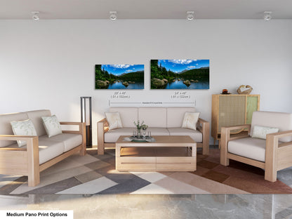 a modern living room with a sofa, two chairs, and a coffee table. There are two framed landscape photographs hanging on the wall above the furniture.