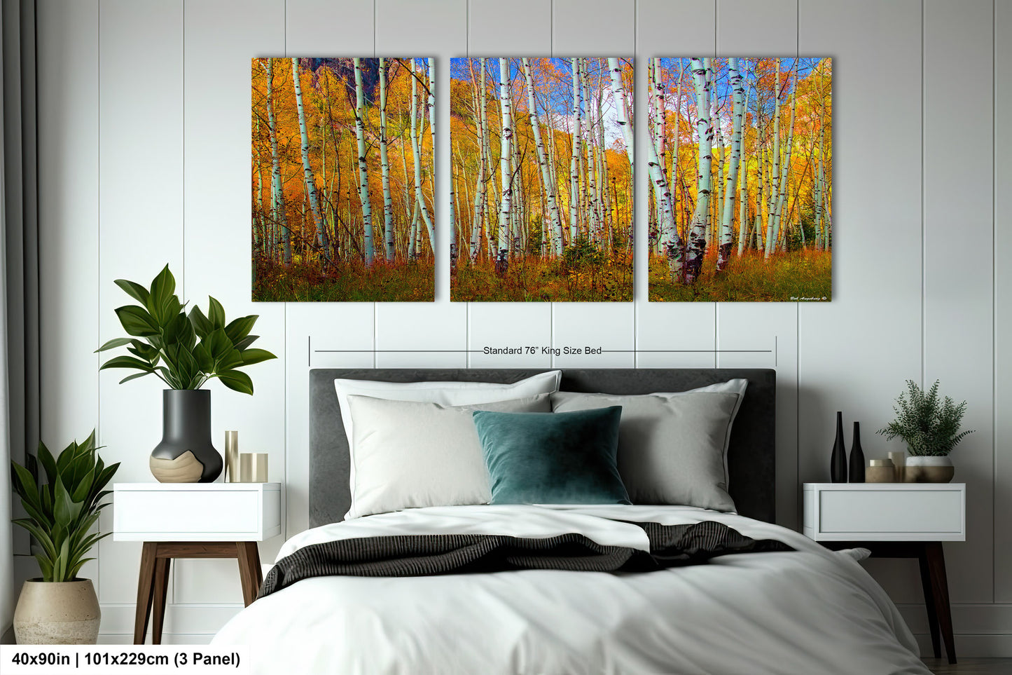 a bed room with a neatly made bed and paintings on the wall