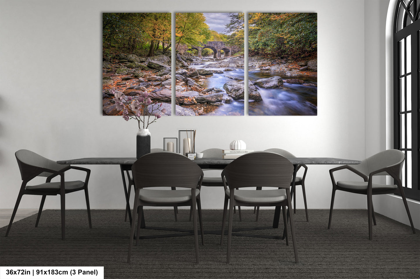 a dining room table with chairs and a painting on the wall