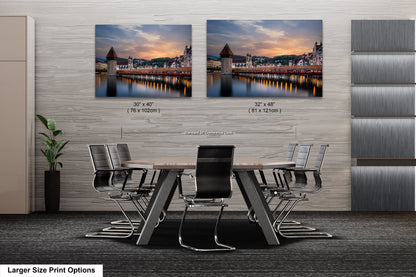a dining room table with chairs and two pictures on the wall