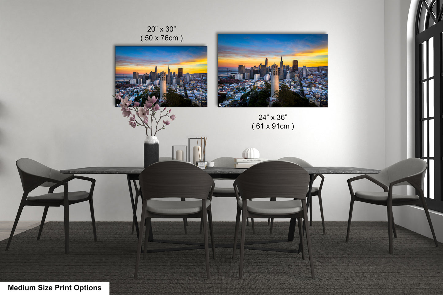 a dining table with four chairs and a vase of flowers