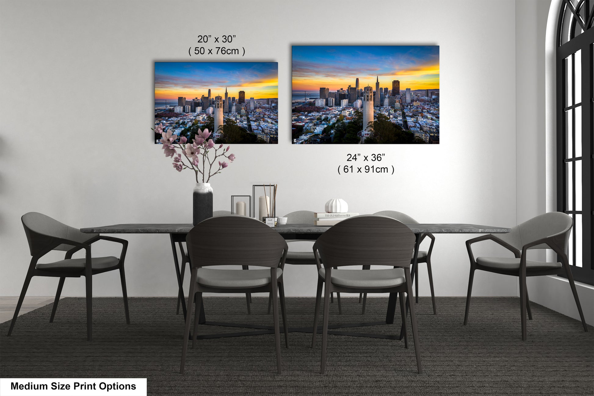 a dining table with four chairs and a vase of flowers