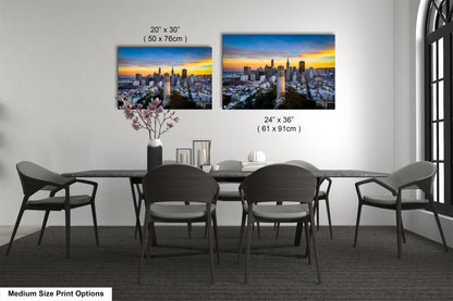 a dining table with four chairs and a vase of flowers