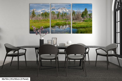 a dining room table with four chairs and a painting on the wall