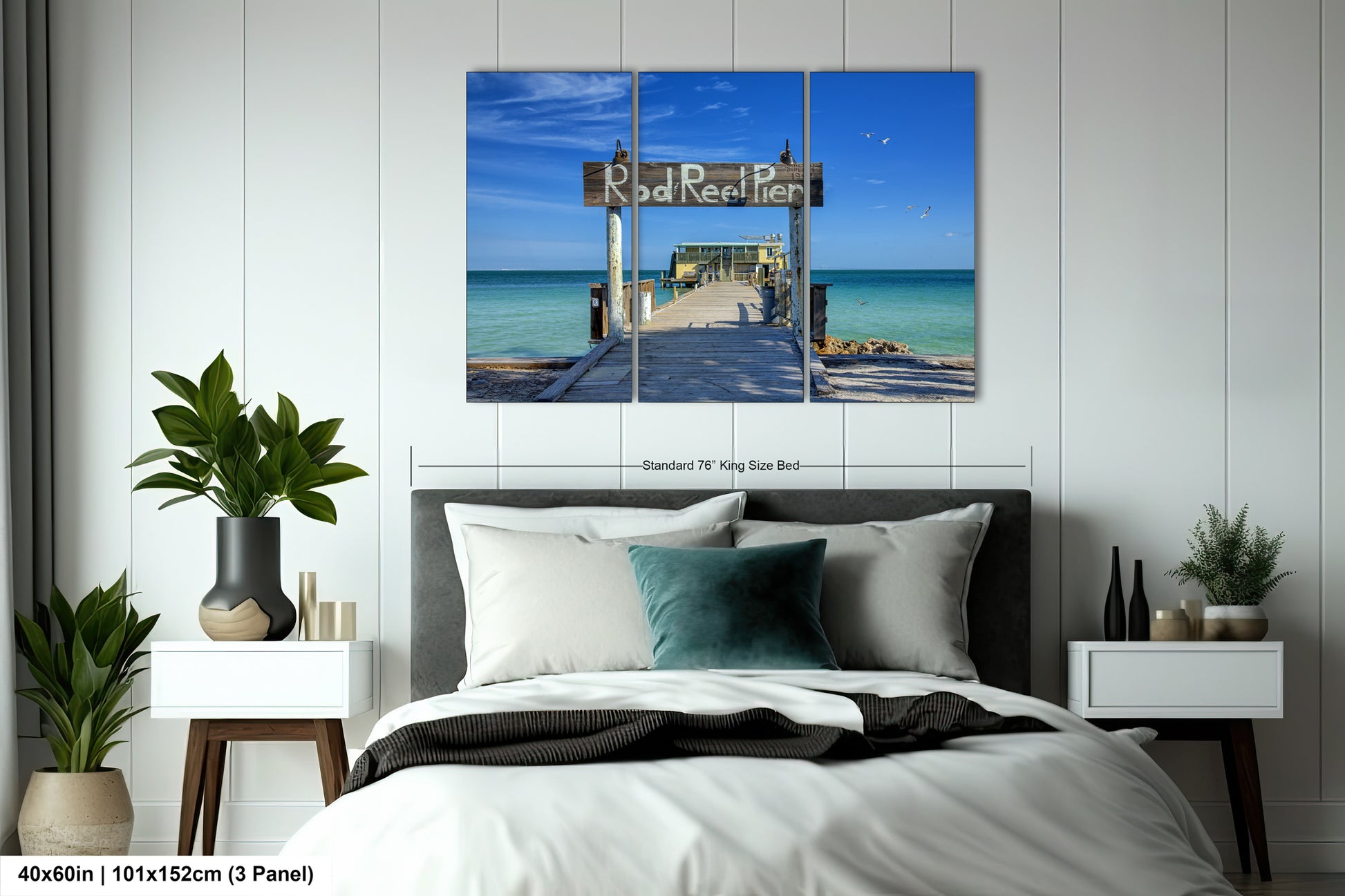 a bed room with a neatly made bed and a painting on the wall