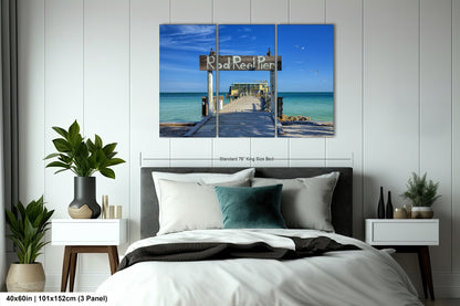 a bed room with a neatly made bed and a painting on the wall