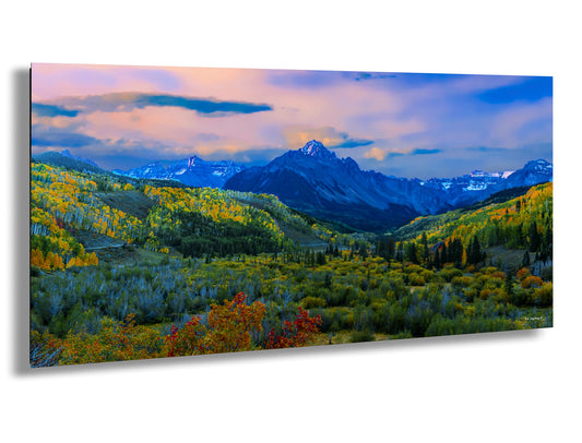a painting of a mountain range with trees in the foreground