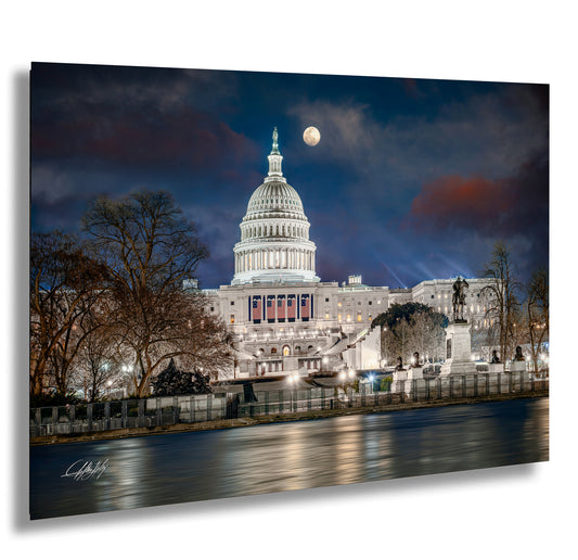 the capitol building is lit up at night
