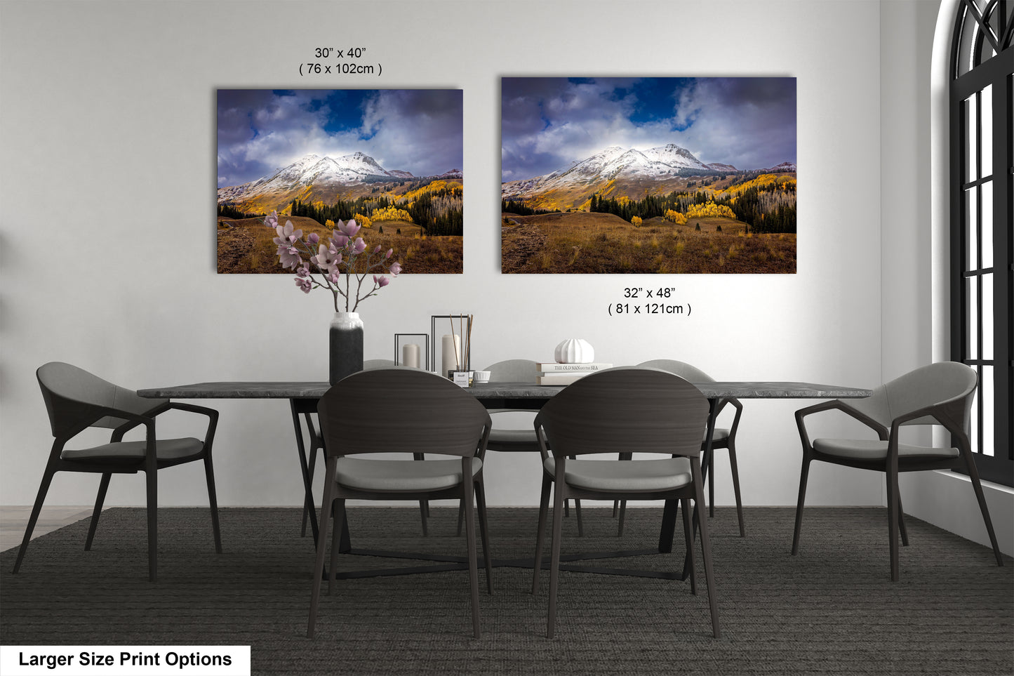 a dining room table with four chairs and a vase of flowers