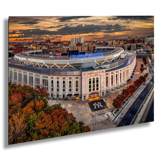 an aerial view of a baseball stadium at sunset
