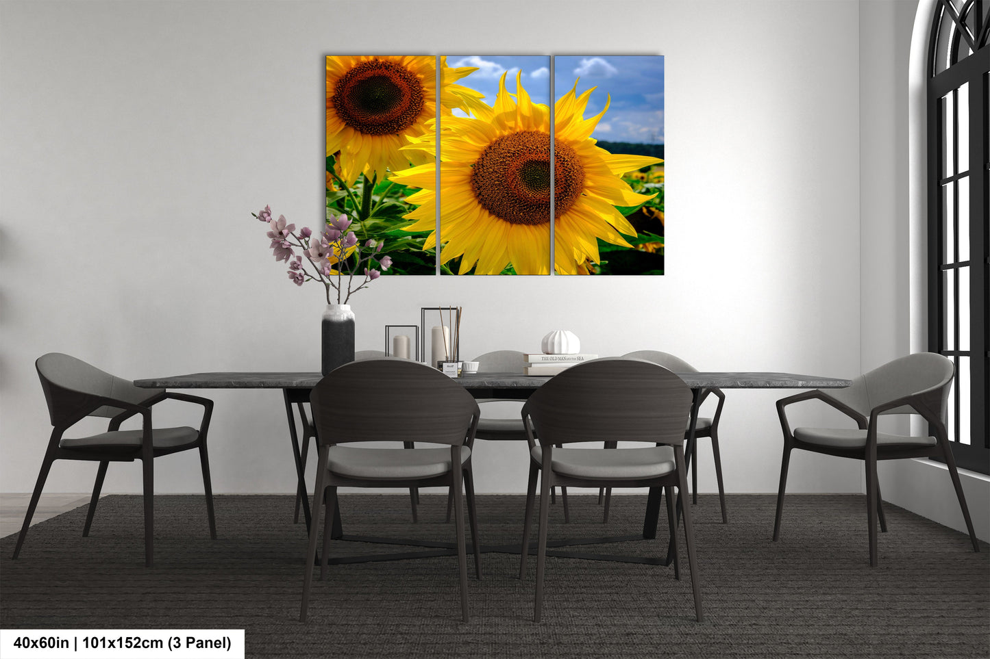 a dining room table with four chairs and a large sunflower painting on the wall