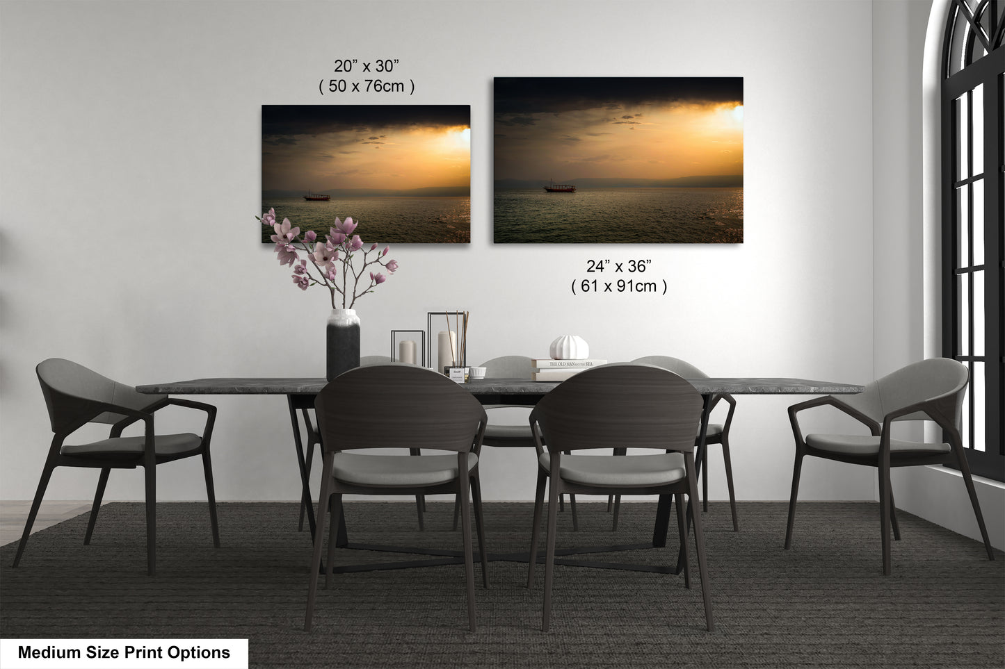 a dining table with four chairs and a vase of flowers