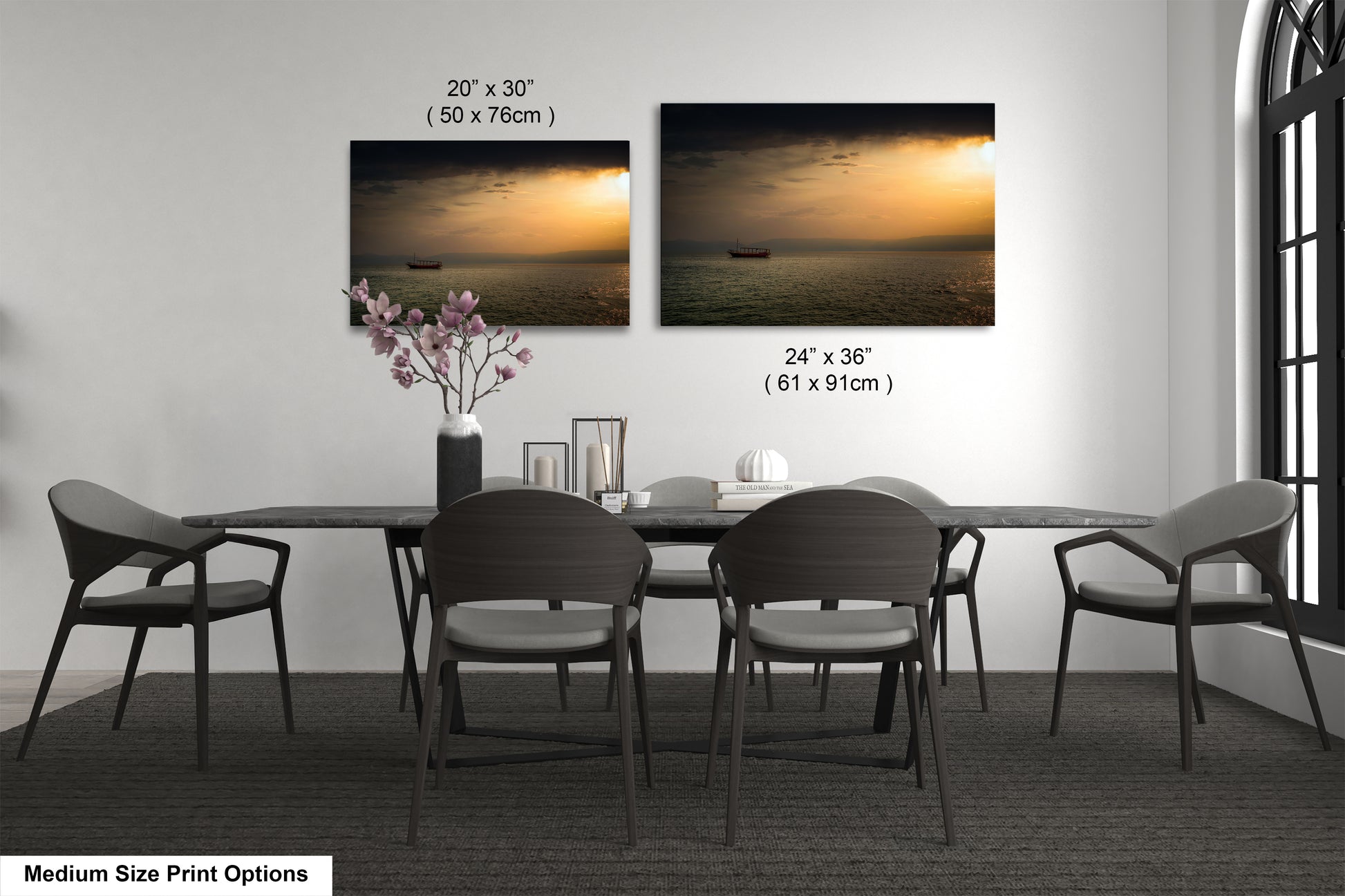 a dining table with four chairs and a vase of flowers