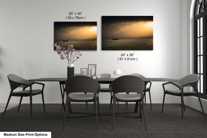 a dining table with four chairs and a vase of flowers