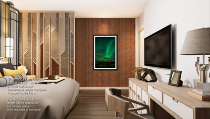 a modern bedroom with a large bed, a wooden dresser, and a framed picture of the northern lights on the wall.