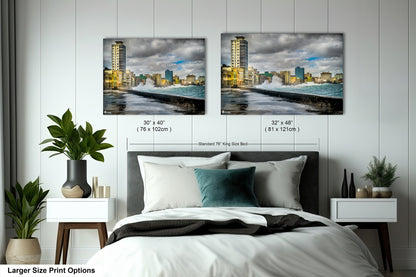 a bedroom with a bed and two pictures on the wall