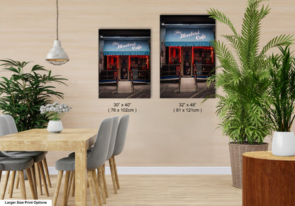 a dining room with a table and chairs next to a potted plant
