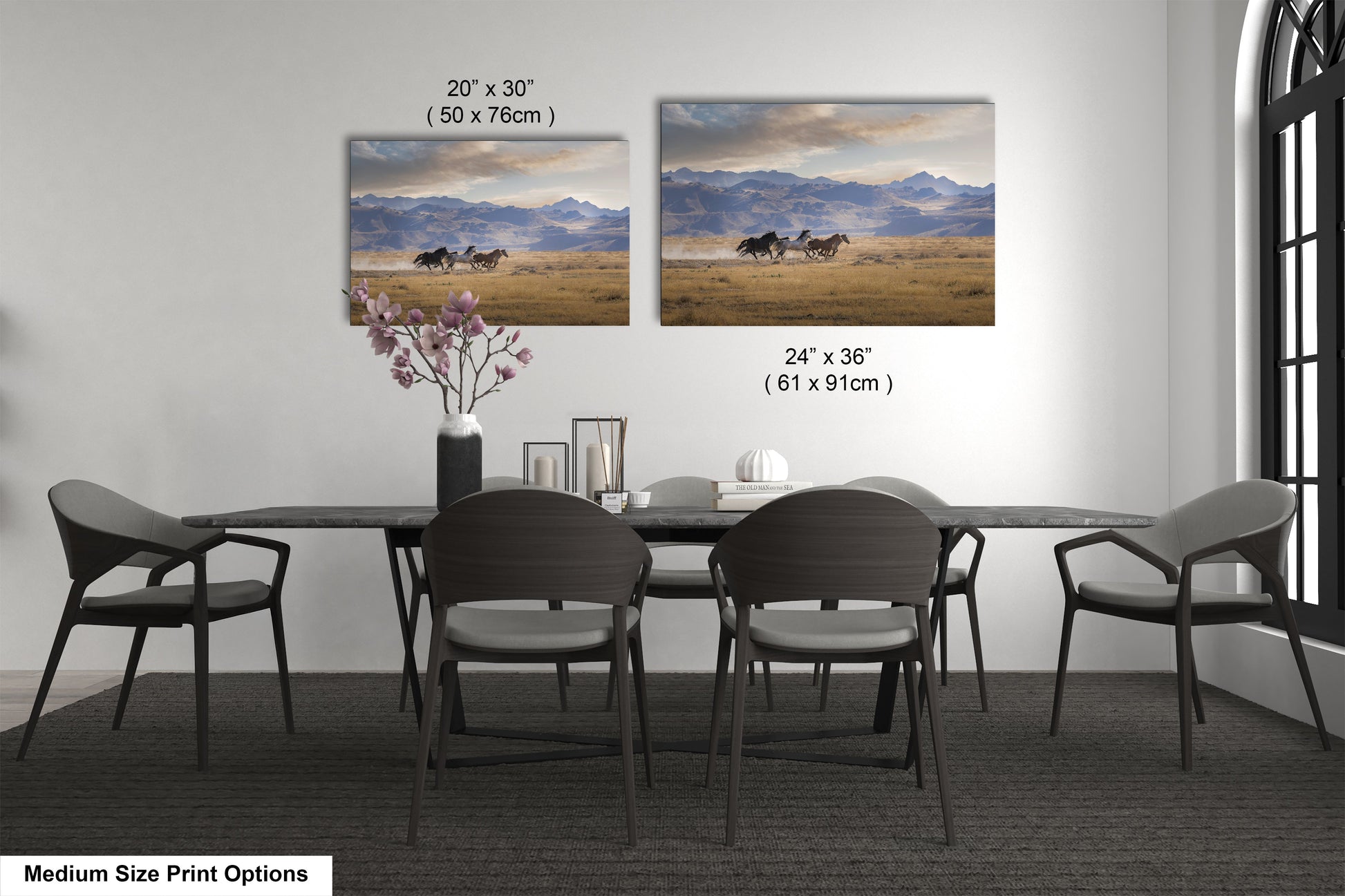a dining table with four chairs and a vase with flowers