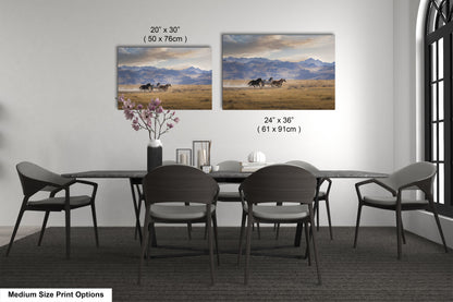 a dining table with four chairs and a vase with flowers