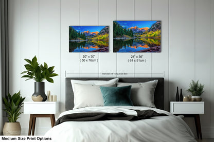 a bed room with a neatly made bed and two paintings on the wall
