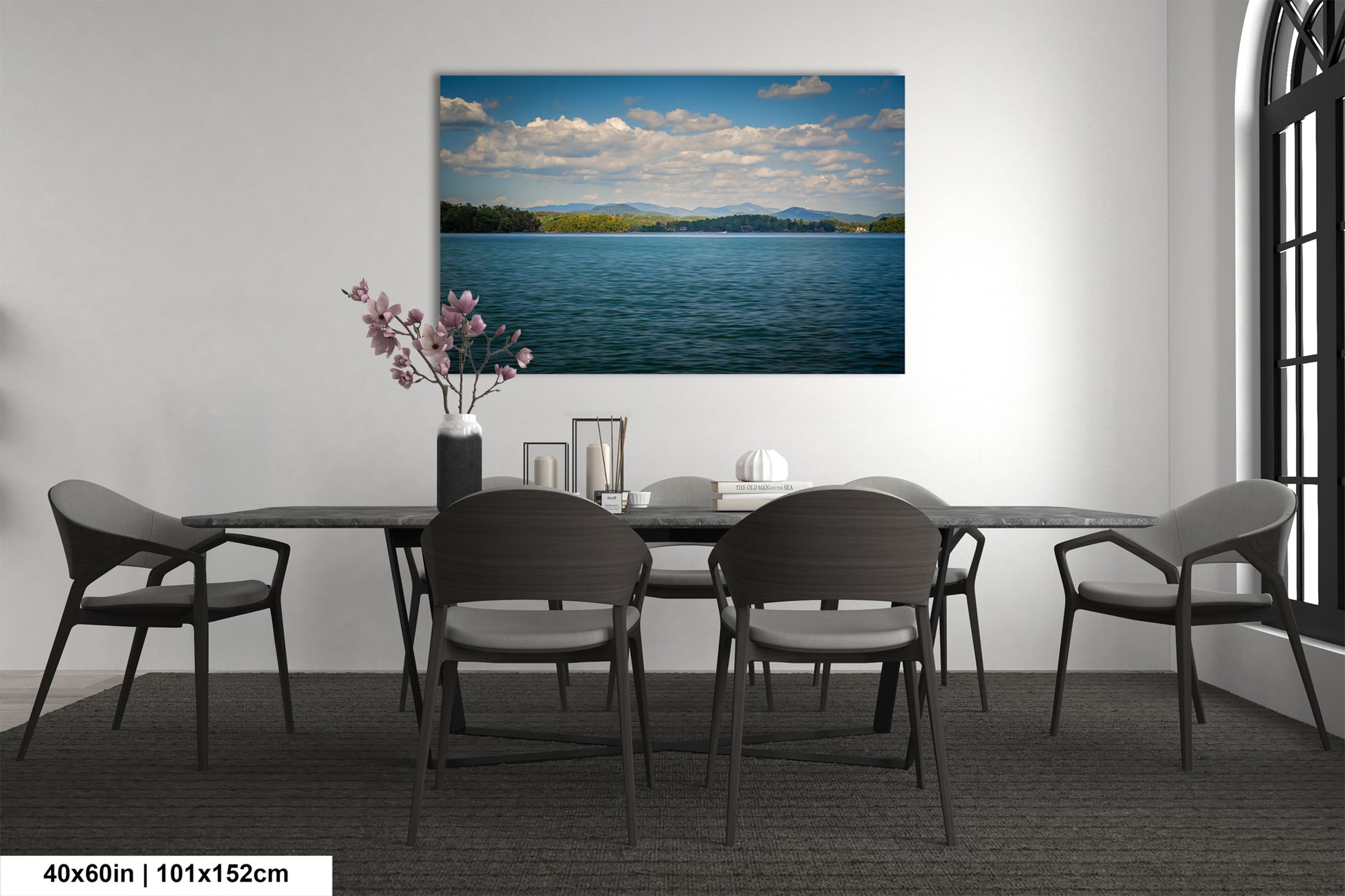 a serene dining room with a large painting of a calm lake and mountains in the background, surrounded by a peaceful atmosphere.