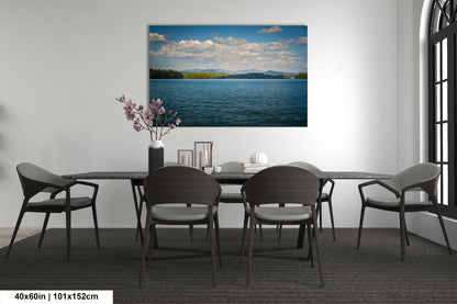 a serene dining room with a large painting of a calm lake and mountains in the background, surrounded by a peaceful atmosphere.