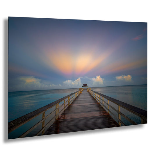 a long pier stretching out into the ocean
