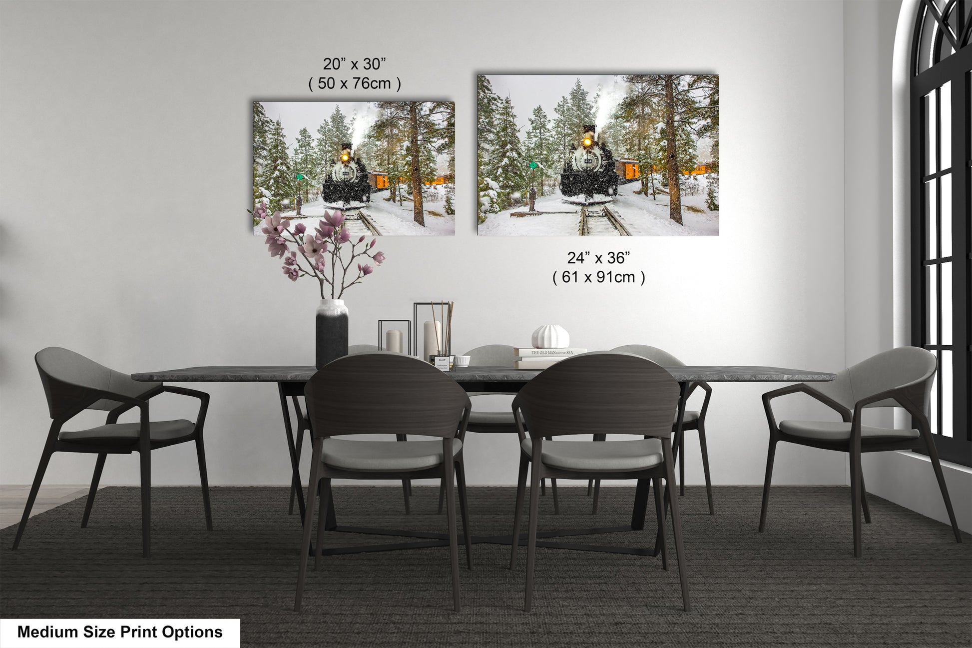 a dining table with four chairs and a vase of flowers