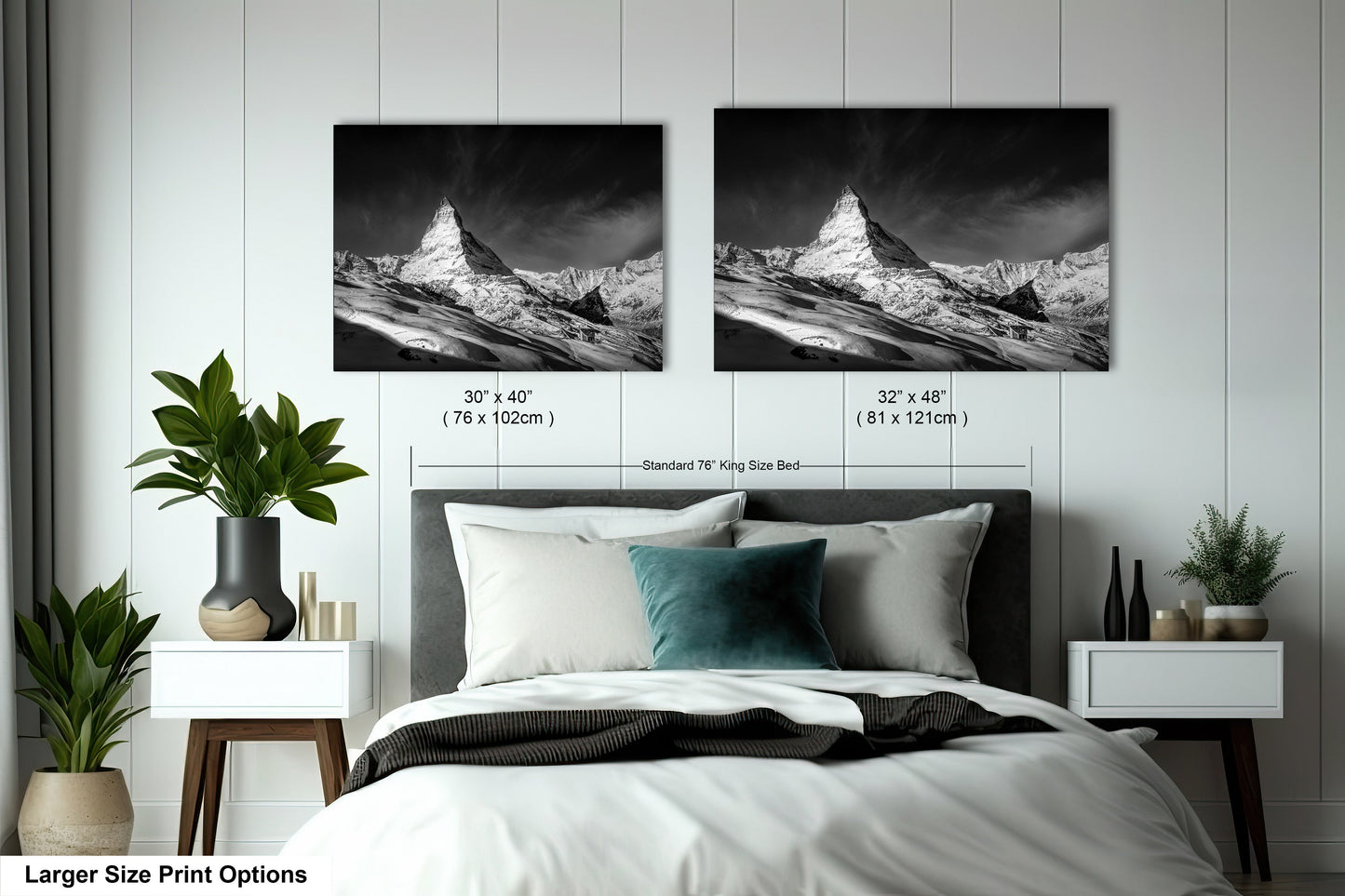 a bed with two pictures on the wall above it