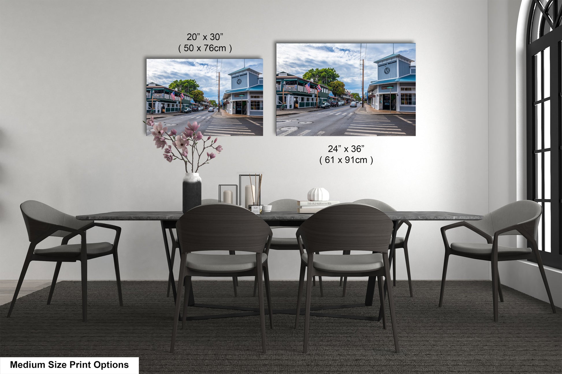 a dining room table with four chairs and a vase of flowers