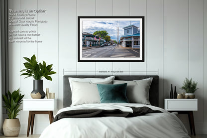 a bedroom with a bed and a picture hanging on the wall