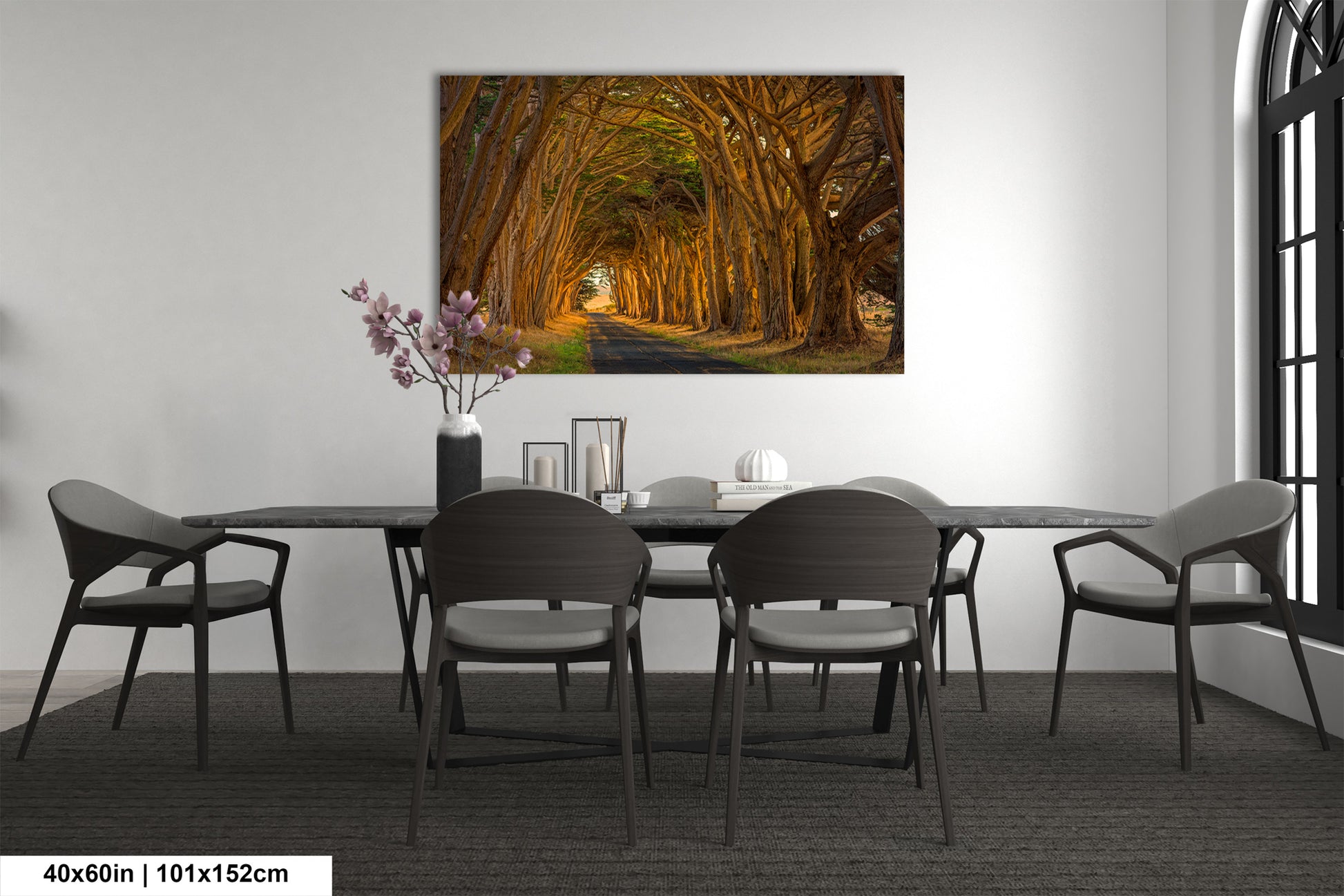 a dining room table with chairs and a painting on the wall