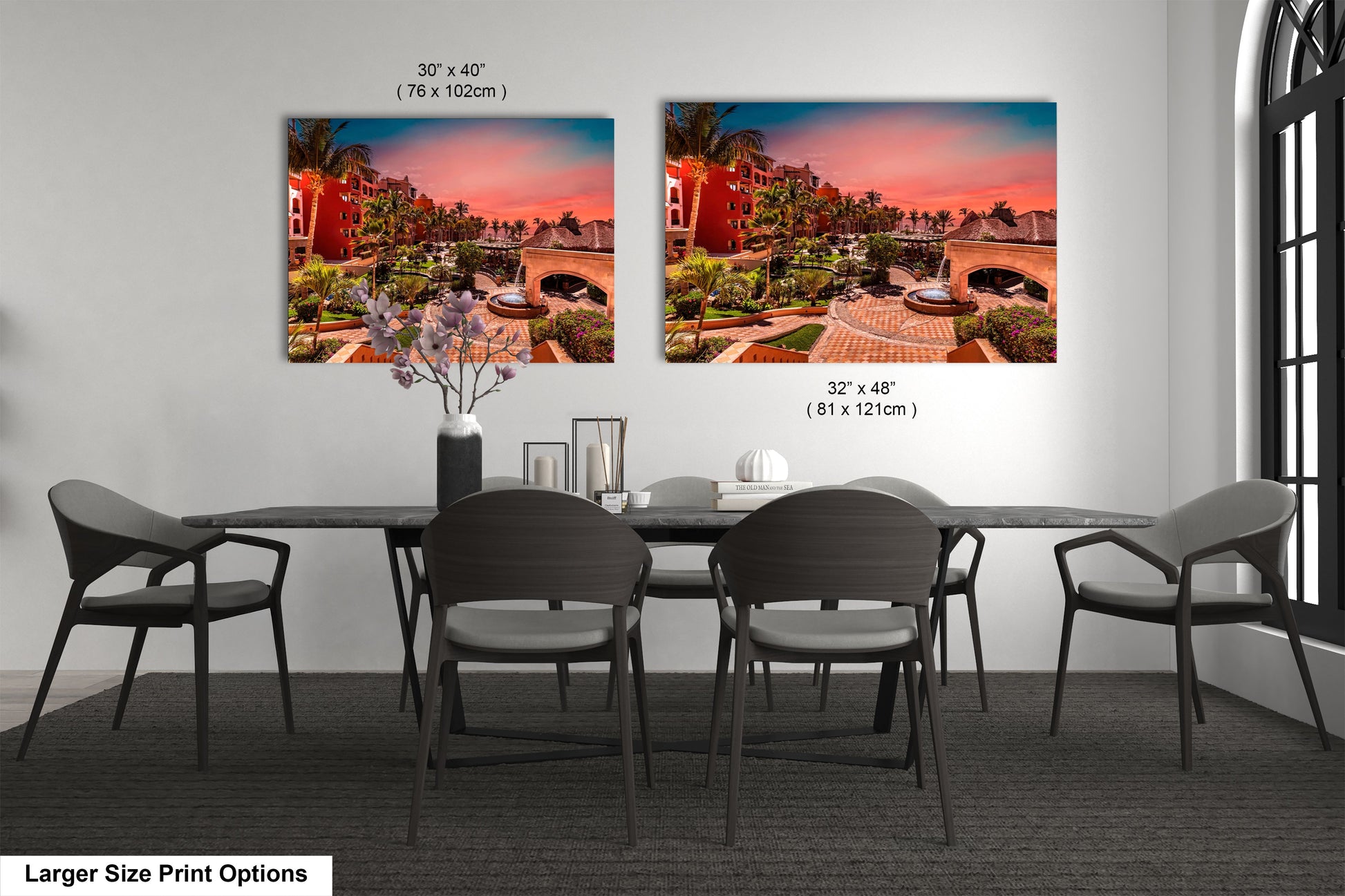 a dining room table with four chairs and a vase of flowers